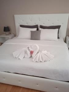 a white bed with a bow on it at Home Away From Home in Skopje
