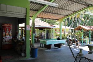 a pool table in the middle of a building at Pousada Vale do Sol in Altônia