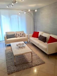 a living room with two couches and a coffee table at Resort Style In Aventura Florida in Aventura