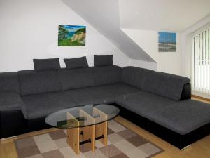 a living room with a couch and a coffee table at Apartment Glowe - GLW661 by Interhome in Klein Gelm