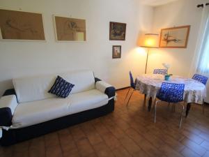 a living room with a couch and a table at Apartment Lo Scoiattolo by Interhome in Belgirate