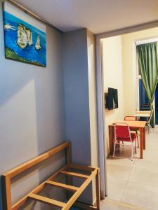 a room with a table and a painting on the wall at Damask Rose, Lebanese Guest House in Jounieh