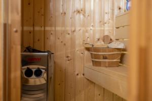 a log cabin with a toilet and a wooden wall at Stay with Gamauf in Fonyód
