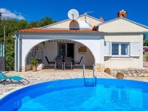 a villa with a swimming pool in front of a house at Holiday Home Kristijana by Interhome in Martina