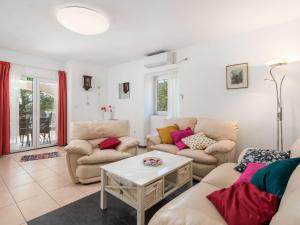 a living room with two couches and a table at Holiday Home Kristijana by Interhome in Martina