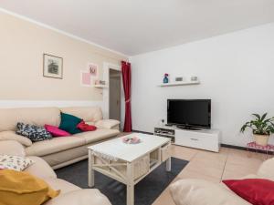 a living room with a couch and a tv at Holiday Home Kristijana by Interhome in Martina