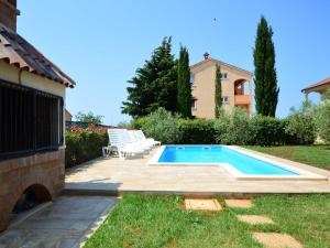 a swimming pool in the backyard of a house at Holiday Home Marko by Interhome in Filipac