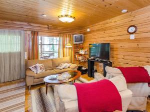 a living room filled with furniture and a tv at Holiday Home Rantakumpu by Interhome in Lieksa +23 photos