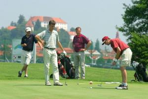 a group of men playing golf on a golf course at Studio apartment "Iris" in Ptuj