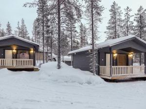 two cottages in the snow in the woods at Holiday Home Pikkuporo b by Interhome in Saariselka