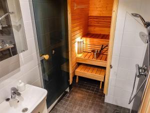 a bathroom with a shower and a sink at Holiday Home Pikkuporo b by Interhome in Saariselka