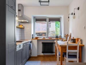 a kitchen with a wooden table and a dining room at Holiday Home Brníčko by Interhome in Brníčko