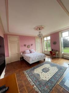 a bedroom with a white bedspread and white walls at CHATEAU DU BOULAY MORIN in Le Boulay-Morin