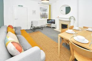 a living room with a couch and a table at Keary House by YourStays, Stoke, with a touch of Scandinavia, 3 bedrooms, BOOK NOW! in Stoke on Trent