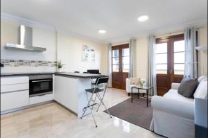 a kitchen and living room with a couch and a table at Apartamento rolycar 103 in Icod de los Vinos