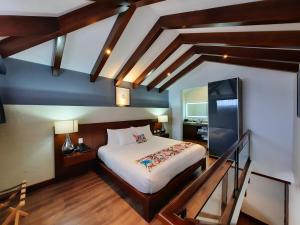 a bedroom with a large bed and a staircase at Casa San Miguel Hotel Boutique y Spa in Zacatlán