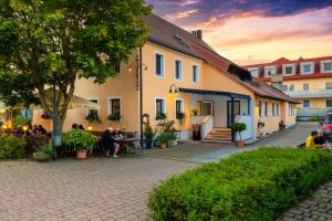 a group of people sitting outside of a building at Hotel-Gasthof Rangau in Ansbach