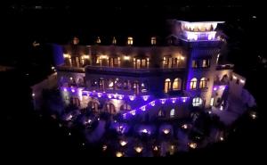 a building with purple lights on it at night at Suter Palace Heritage Boutique Hotel in Bucharest