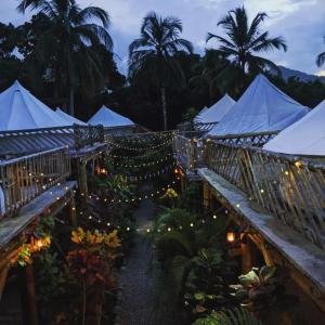 a garden with white tents and lights at night at Glamping Due Amici in Palomino