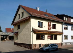 a small car parked in front of a building at Boardinghouse Remchingen Baan Arun in Remchingen