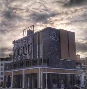 un edificio con un cartel en el costado en Point 11 Residence, en Damieta