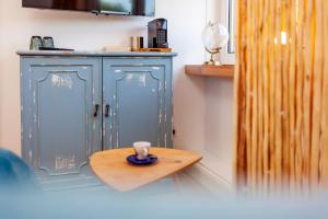 a small wooden table with a cup on top of it at Relitto Boutique und Aparthotel Borkum in Borkum +50 photos