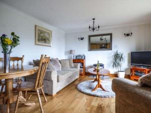 a living room with a couch and a table at Low Dow Crag in Coniston