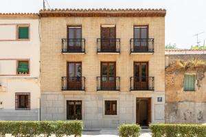 a brick building with windows and balconies at Double Room in ToledoRooms VistaPark in Toledo