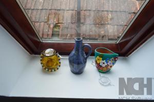 three vases are sitting on a window sill at La Mos Pavel in Noşlac