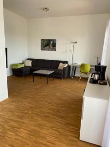 a living room with a couch and a table at Penthouse 34 -rollstuhlgerecht- in Oerlinghausen