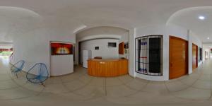 a hallway with two chairs and a table in a room at Hotel VidaMar in Puerto Escondido