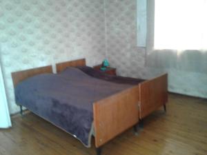 a bedroom with a bed with a blanket on it at Levani's GuestHouse in Zugdidi