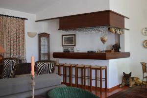 a living room with a dog sitting on the floor at Tranquilidade Alentejana in São Cristóvão