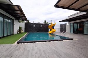a swimming pool in the backyard of a house at Lux9 Private Pool Villa HuaHin in Hua Hin