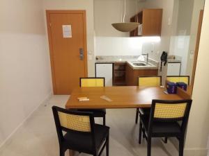 a kitchen with a wooden table and chairs at Apartamento no Salinas Exclusive Resort in Salinópolis