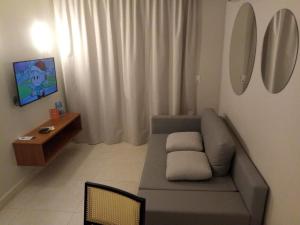 a living room with a couch and a table at Apartamento no Salinas Exclusive Resort in Salinópolis