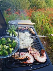 a grill with meat and vegetables on it at Cois Farraige in Eadargóil
