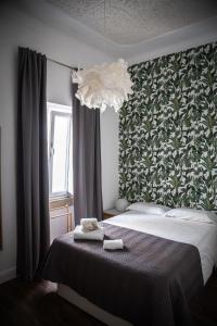 um quarto com uma cama e um lustre em Elvas the Queen Residence em Elvas