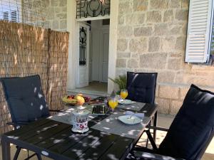 a wooden table with two glasses of orange juice on it at Apartments Kirigin in Dubrovnik