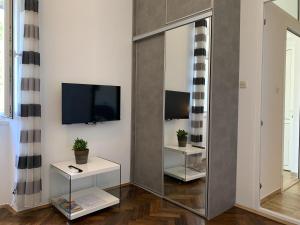 a large mirror in a living room with a tv at Apartments Kirigin in Dubrovnik