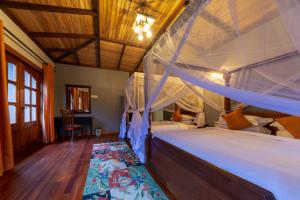 a bedroom with two bunk beds in a room at Chimpundu Lodge in Fort Portal