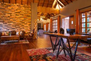 a living room with a table with two cats on it at Chimpundu Lodge in Fort Portal