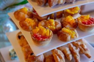 a display of pastries with fruit on top of them at Chimpundu Lodge in Fort Portal