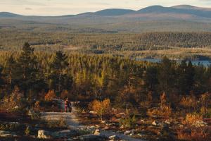a person walking on a trail in the mountains at Lapland Dream Villas in Rauhala