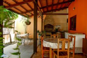 a kitchen with a table and chairs and a fireplace at Pousada aconcheg'us in Jijoca de Jericoacoara