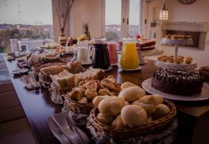 a buffet with cakes and pastries on a table at Pousada Lanai Gramado in Gramado