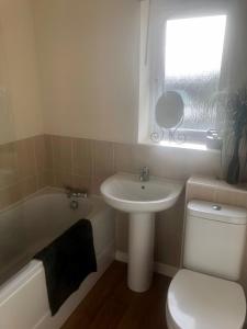 a bathroom with a sink and a toilet and a bath tub at Brockwell - 2 Bed Modern Home, Near City Centre in Bowburn