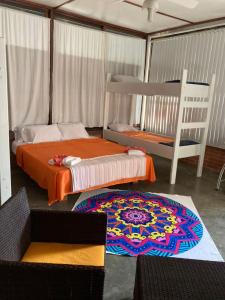 a bedroom with two beds and a rug on the floor at Sleep'n'Ride in El Yaque