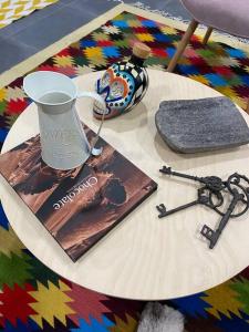 a table with a book and a cup of coffee and a book at NUEVO, Moderno departamento en la zona de SANTA FE in Mexico City