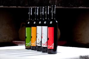 a row of wine bottles sitting on a table at El Ventorro Hospederia Rural in Alhama de Granada